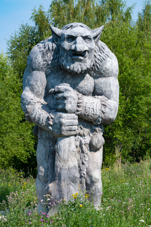 SHEVELEVO, RUSSIA - AUGUST 06, 2023: Sculpture of a stone troll on the edge of a forest. Ethnopark Holmgard. Novgorod regionのeditorial素材