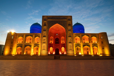 BUKHARA, UZBEKISTAN - SEPTEMBER 11, 2022: Mir-i-Arab Madrasah in night illumination on a early morningのeditorial素材