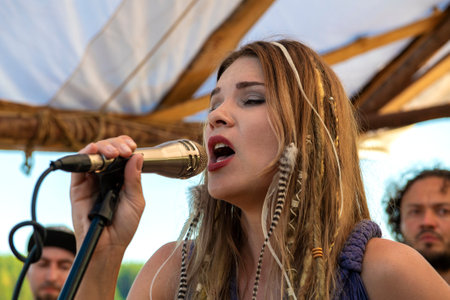 TVER REGION, RUSSIA - JULY 24, 2023: Olga Kondrus - soloist of the folk group "Olya and the Brownies". A fragment of a performance on the festival of the "Epic Coast-2022"のeditorial素材