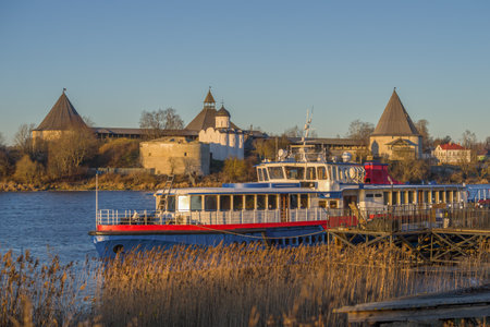Docked old pleasure ship against the backdrop of the ancient Old Ladoga fortress on a sunny December morning. Leningrad region, Russiaのeditorial素材