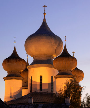 Domes of the Assumption Cathedral of the Tikhvin Assumption Monastery in the evening accent lighting...