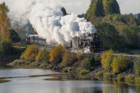 HELYULYA, RUSSIA - OCTOBER 06, 2023: Retro train "Ruskeala Express" in the autumn landscape. Kareliaのeditorial素材