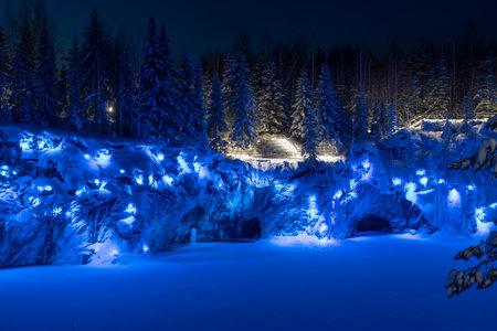 Frosty January night with blue illumination in Marble Canyon. Ruskeala Mountain Park. Karelia,...