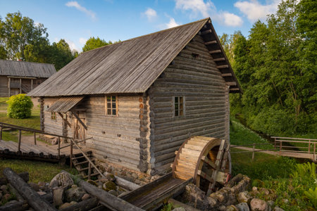BUGROVO, RUSSIA - JUNE 12, 2024: Wooden water mill on a sunny June morning. Museum complex Miller's Estate in Bugrovo. Pushkinskie Goryのeditorial素材