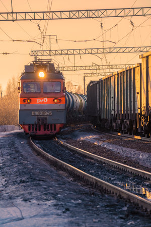 SHARYA, RUSSIA - MARCH 19, 2022: Electric locomotive VL80t-1945 with a train on a turn on a sunny...