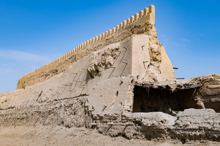 Fragment of an ancient urban defensive wall on a sunny day. Bukhara, Uzbekistan