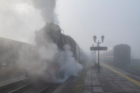 SORTAVALA, RUSSIA - The retro train "Ruskeala Express" at the Sortavala station platform on a foggy October morningの写真素材