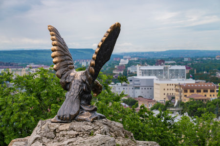 PYATIGORSK, RUSSIA - Sculpture the eagle against the background of a cityscape on a cloudy June morning. Caucasian mineral watersの写真素材