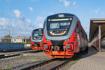 RYBINSK, RUSSIA - AUGUST 25, 2024: Suburban diesel train RA3 "Orlan" at the platform of the Rybinsk railway station on a sunny dayのeditorial素材