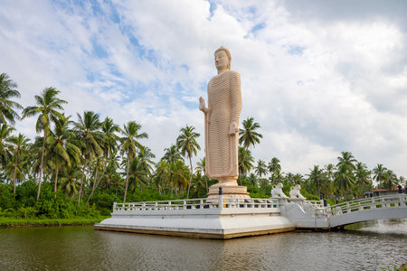 PERALIYA, SRI LANKA - Sculpture of a standing Buddha. Memorial to the victims of the tsunami. Tsunami Honganji Viharayaの写真素材
