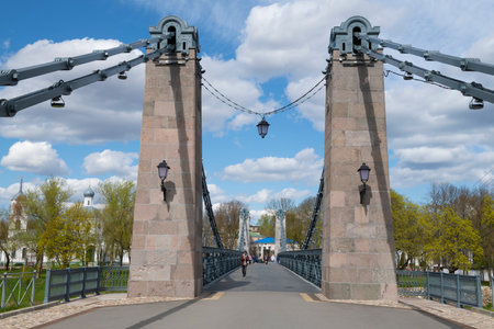 OSTROV, RUSSIA - MAY 08, 2022: On the ancient suspension chain bridge on a May dayのeditorial素材