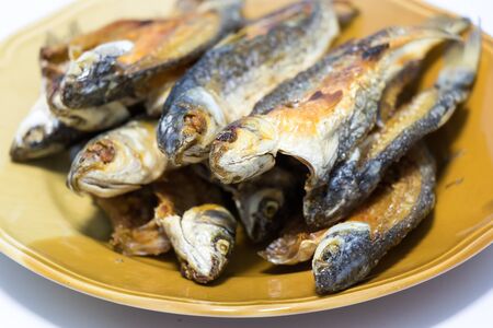 Fried mullet fish in the plate