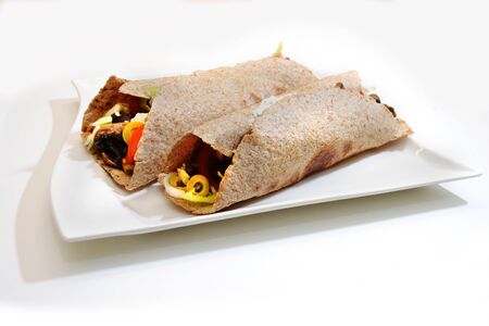 tortilla wraps on a plate isolated white backgroundの写真素材