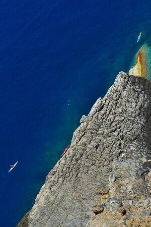 three canoes at the blue seaの写真素材