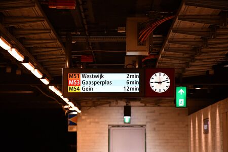 metro sign displaying arrival timeの写真素材