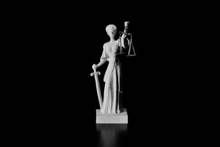 Lady Justice on black background isolatedの写真素材