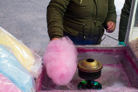 Process of Making sweet cotton candy. Street candy floss machine