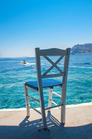 Traditional greek chear on the seaside. Travel concept of early bookingの写真素材