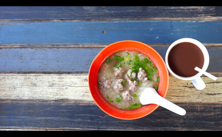 Gruel pork soup and chocolate - coco milk resort breakfast retro wood desk blue color tone trip at...