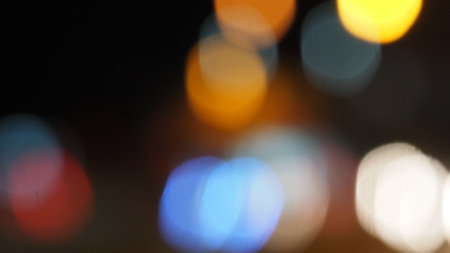 Bokeh blur zoom at lighting on the road are circle shape background black color.