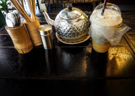 Background coffee and property on wood desk in coffee shop at Bangkok Thailand retro concept, Macro photo focus select at aluminum pot.の写真素材