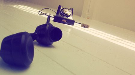 Background antique telephone, Retro photo perspective dimension and oblique is art style, Object on the white wood floor has sun lighting is nice shot.の写真素材