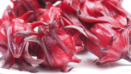 Background fresh roselle flower fruit close up full frame on white.の写真素材