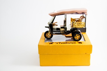 Tuk tuk Model Taxi Thailand gold and copper color on yellow box on white background - Thai souvenirsの写真素材