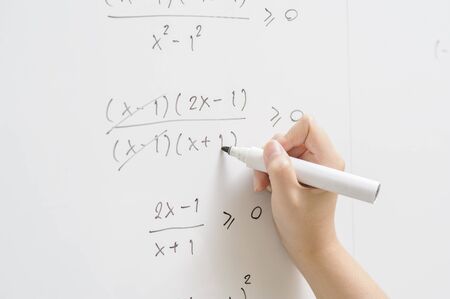 a hand writing on whiteboard