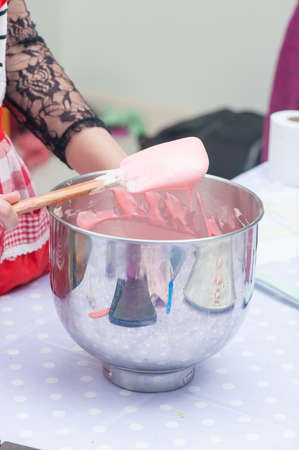 mixed bakery ingredients with spatula and steel bowl の写真素材