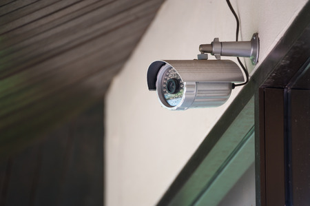 Silver CCTV Camera on the white wallの写真素材