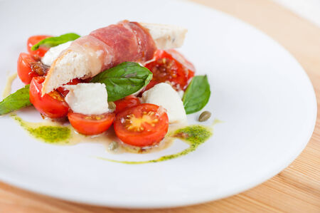 Tomato , Fresh Mozzarella , Bread&Parma , Pesto Sauce and Light Tonkutsu Dressingの写真素材