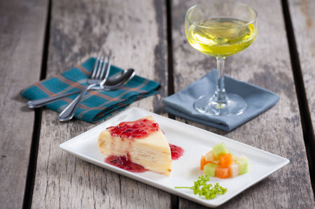 White crepe cake on wood table.の写真素材