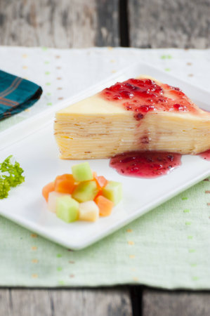 White crepe cake on wood table.の写真素材