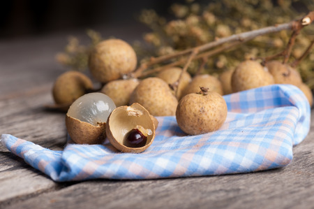 Longan (Dimocarpus longan.) on wood table. with low key scene.の写真素材