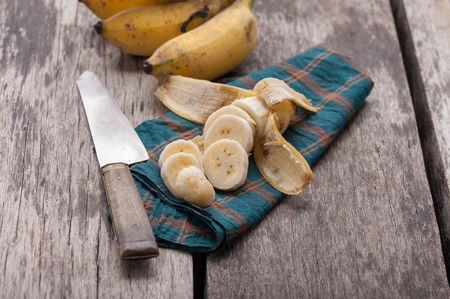 Sliced ripe banana on wood table.の写真素材