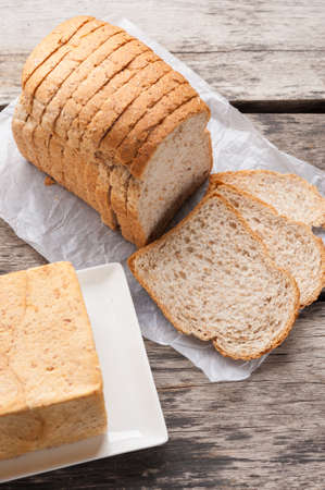 Sliced whole wheat bread on table.