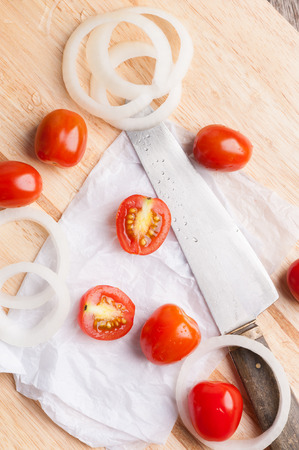 Red small tomatoes on wood board.の写真素材