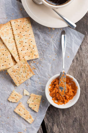 Biscuits with a cup of coffee and Thai tea cream on table