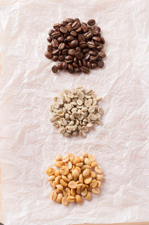 Three kinds of coffee beans on crumpled paper.の写真素材