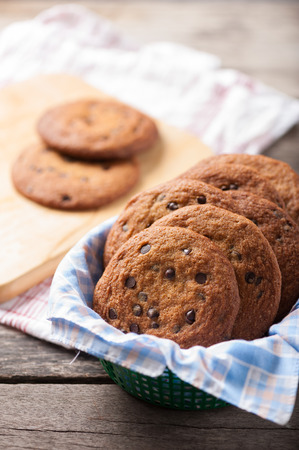 Fresh chocolate chip cookies setting on wood tableの写真素材