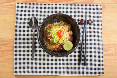 Rice with fried chicken, japanese style sauce and spring onionの写真素材