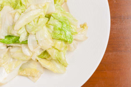 Fried cabbage with fish sauce in white dish.の写真素材
