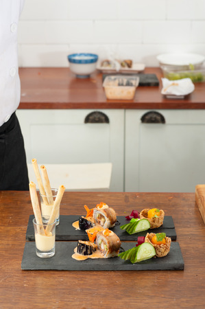 Spring roll stuffed with seaweed and Mentaiko served with mango wasabi mayo, Grilled eggplant with Scallop spicy cheese, Tako tempura roll and Namasu Kabayaki, Kumquat stuffed with smoked duck and mash potato in the noodle nest, Japanese fusion foodの写真素材