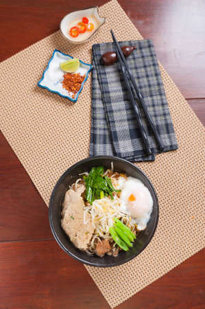 Japanese noodle  with Thai spicy soup, pork and onsen egg.の写真素材