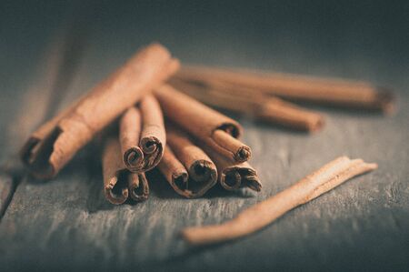 Cinnamon sticks on wood table with film filter effectの写真素材