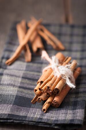 Cinnamon sticks on wood table with low key sceneの写真素材
