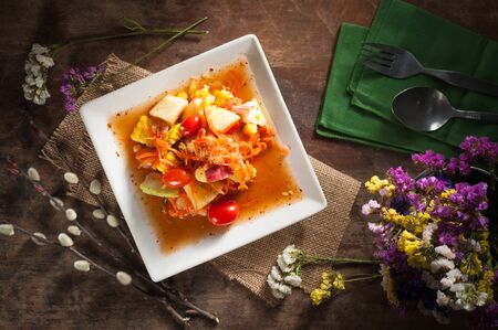 Thai mix fruit spicy dressed salad with low key sceneの写真素材