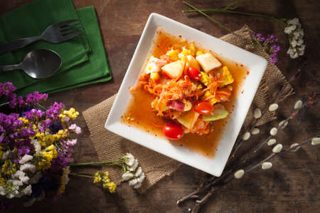 Thai mix fruit spicy dressed salad with low key sceneの写真素材