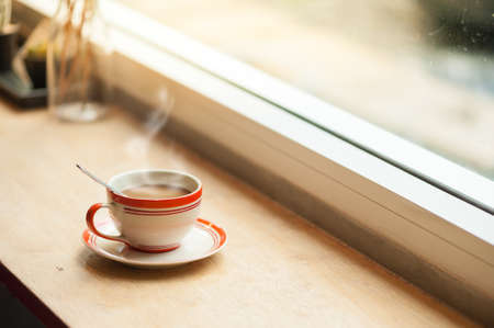 Milk coffee in coffee cup on wood bar